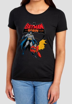 Black t-shirt with colorful Batman and Robin comic graphic and text "Batman with Robin the Teen Wonder" worn by person in blue jeans.