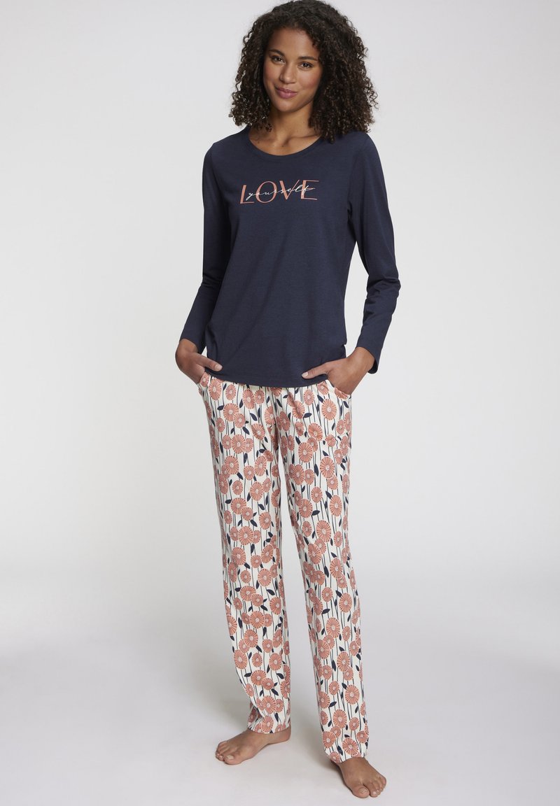 Long-sleeve navy top with "LOVE" graphic; floral-patterned pants in pastel colors with vertical stripes and pockets. Soft cotton material.
