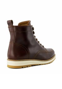 Brown leather ankle boot with a smooth texture, round toe, stitched accents, and a white and light brown sole. Features brown lace-up design.