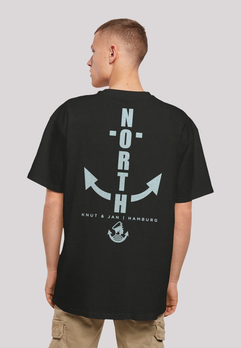 Black t-shirt featuring a vertical "NORTH" text, arrows, and a graphic logo in light blue on the back. Loose fit, short sleeves, cotton material.