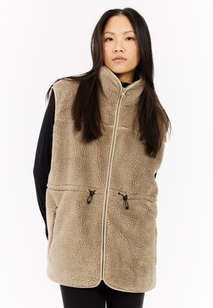 Beige fleece vest met hoge kraag, ritssluiting aan de voorkant en twee ritssluitingen zakken. Beschikt over een gestructureerde stof en contrasterende bies langs de randen.