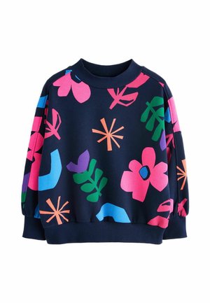 Navy blue sweatshirt with ribbed collar and cuffs, featuring large colorful abstract floral and leaf patterns in pink, green, blue, purple, and orange.