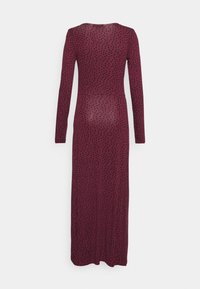 Vestido de manga longa, cor bordô, feito de tecido leve, apresentando um padrão de bolinhas pretas. Forma ajustada com decote redondo.