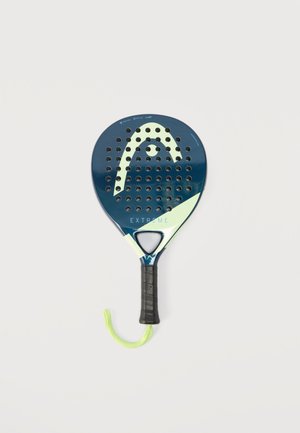Mørkeblå og lysegrøn padelracket med perforeringer, sort grebshåndtag og grønt håndledsrem, mærket "EXTREME" på forsiden.