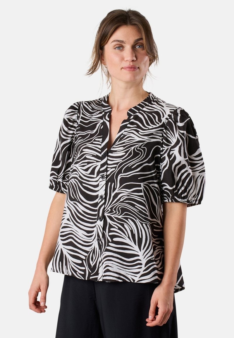 Black and white button-up blouse featuring a wavy leaf pattern, short puff sleeves, and a soft, lightweight fabric.