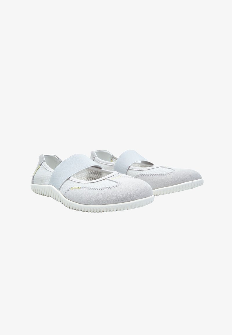 White slip-on shoes with a soft suede texture, mesh sides, and an elastic strap across the top. Flexible rubber soles with textured tread.