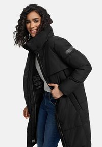 Black puffer coat with high collar and full zip closure. Features a quilted texture and logo detail on the sleeve. Interior pocket visible.