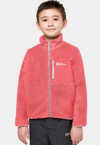 Coral-colored fleece jacket with a zip front, high collar, and a contrasting pocket. Soft texture and embroidered logo on the chest.