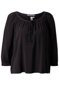 Blouse noire à manches longues avec encolure froncée et détail noué à l'avant, coupe ample et poignets élastiques.