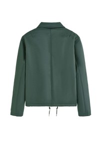 Veste verte en tissu lisse et texturé. Présente un col classique et un ourlet à cordon de serrage avec embouts en métal, et a une coupe décontractée.