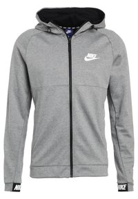 Grå Nike-hoodie med hel dragkedja, svart dragkedja, justerbar huva, vit Nike-logotyp på bröstet och ärmslut samt svart innertyg i huvan.