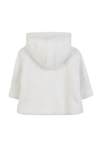 Sweat-shirt blanc à capuche, à manches courtes et motif tricoté texturé. Le tissu présente des fils métalliques subtils pour un effet scintillant.