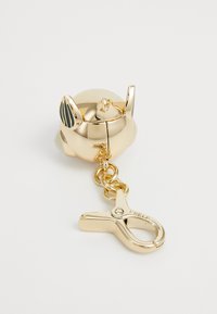 Gouden sleutelhangeraccessoire in de vorm van een cartoonesk dierenhoofd, met een glanzende metalen afwerking, uitstekende oren en een haakje.