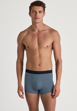 Marineblaue Boxershorts mit Wellenmuster, ausgestattet mit einem elastischen Bund mit Markenlogo. Das Material hat eine glatte Textur und eine enganliegende Passform.