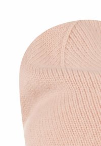 Strikket hue i blød pink. Har en afrundet top, ribbet tekstur og diskret syning langs kronen for en tætsiddende pasform.