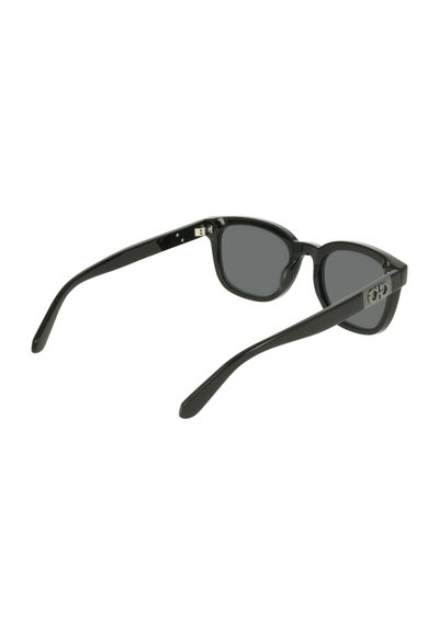 Black plastic sunglasses with dark lenses, tapered arms, and a subtle logo on the side. Smooth texture and classic shape.