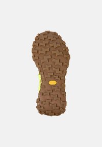 Brown Vibram outsole with pronounced, textured lugs for traction. Features a yellow accent near the heel, marked with size 42.