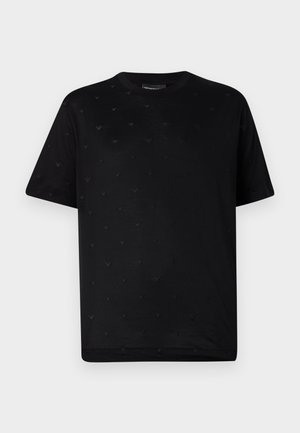 Black cotton t-shirt featuring a textured pattern of small, raised, V-shaped accents across the fabric, crew neckline, and short sleeves.