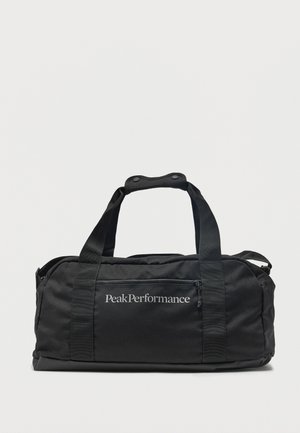 Sac de sport rectangulaire noir avec doubles poignées et poche zippée à l'avant, marqué "Peak Performance" en texte blanc au centre.