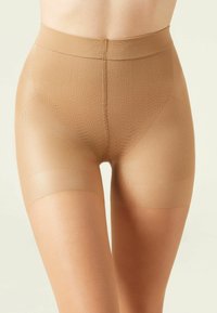 Beige sømløse formende shorts med et struktureret mønster, midt på låret længde og elastisk talje for komfort og støtte.
