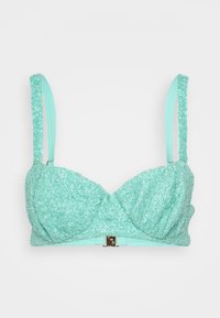 Μπραζίνα σε μέντα πράσινο χρώμα με χάντρες και υφή, διαθέτει ρυθμιζόμενους ιμάντες και μεταλλικό κούμπωμα στο κέντρο μπροστά.