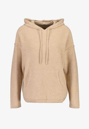 Beige huppari, joka on valmistettu pehmeästä kankaasta, sisältää kengurupocketin, narut ja rentoa istuvuutta roikkuvilla harteilla.