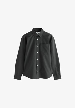 Črna dolga srajca s kravato, z enim žepom na prsih in belimi gumbi, izdelana iz gladkega bombažnega materiala.