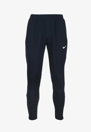 Pantalones deportivos de color azul marino, confeccionados con una tela suave, con una cintura elástica, piernas ajustadas y un logo de Nike en blanco en la parte delantera.
