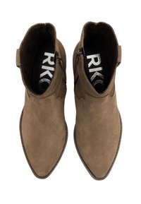 Brown suede ankle boots with pointed toes, featuring a scalloped upper edge and side zippers. Interior has black lining with logo.