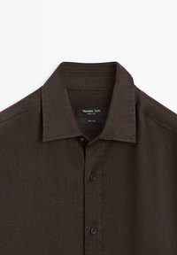Dark brown linen button-up shirt with pointed collar from Massimo Dutti, showing top two buttons and brand label inside collar.