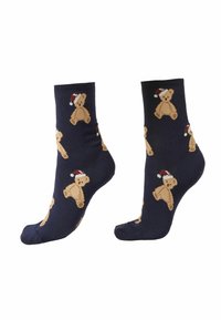 Marine-sokker med strikkede bamse-motiver, der bærer røde og hvide julestråhatte, med en blød bomuldsstruktur og elastiske manchetter.