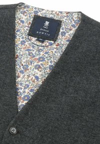 Dark gray cardigan with a v-neck, featuring a floral-patterned lining in soft blue, orange, and yellow tones. Single button closure.