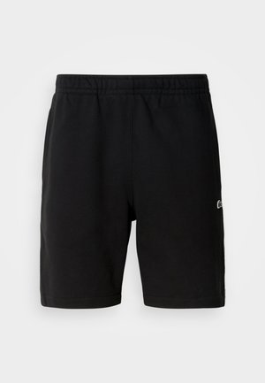 Čierne šortky s elastickým pásom a malým logom na pravej nohe, vyrobené z mäkkej tkaniny a s voľným strihom.