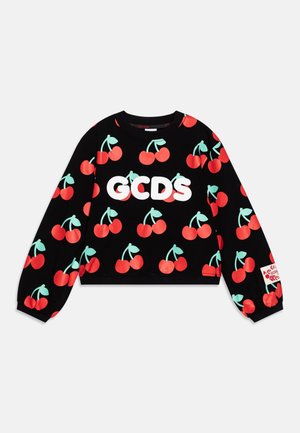 Black long-sleeve sweatshirt with red cherry print and green stems, featuring large white "GCDS" letters across the chest and a sleeve logo patch.