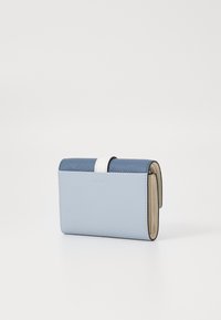 Portafoglio blu in pelle con superficie strutturata, dotato di una fascia accento bianca, design pieghevole e interno di colore chiaro.