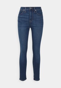 Högtaliga skinny jeans i mörkblå denim, med en klassisk femficksdesign, subtil blekning och dragkedja med knappstängning.