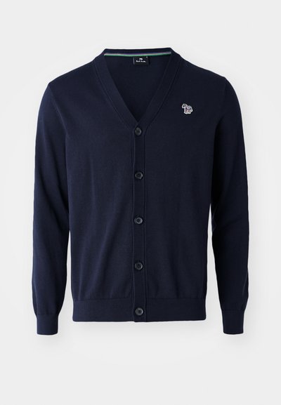 Námornícky pletený sveter s výstrihom do V, piatimi čiernymi gombíkmi a malým farebným logom na ľavej hrudi. Hladká textura, dlhé rukávy.