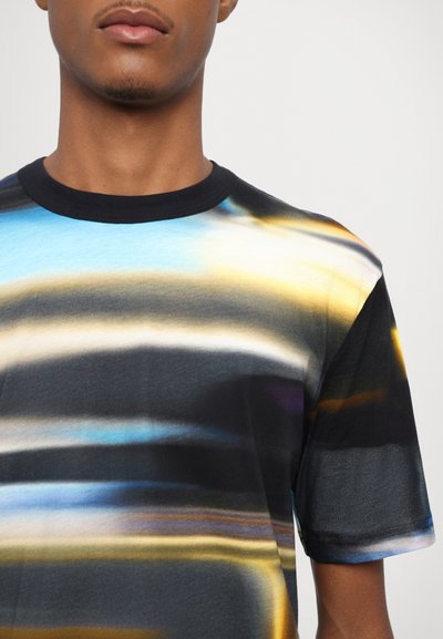 Short-sleeve T-shirt featuring a black base with abstract wavy patterns in blue, gold, and white. Soft fabric with a crew neck design.