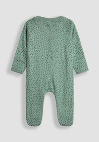 Body verde per bebè con maniche lunghe e motivo a pois texturizzati. Presenta una chiusura con bottoni sul retro e un collo rotondo. Materiale morbido.