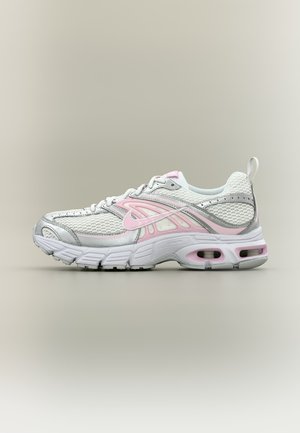 Baskets de sport blanches et rose clair avec empeigne en mesh, semelle rembourrée et languette à l’arrière, présentées en profil sur fond neutre.