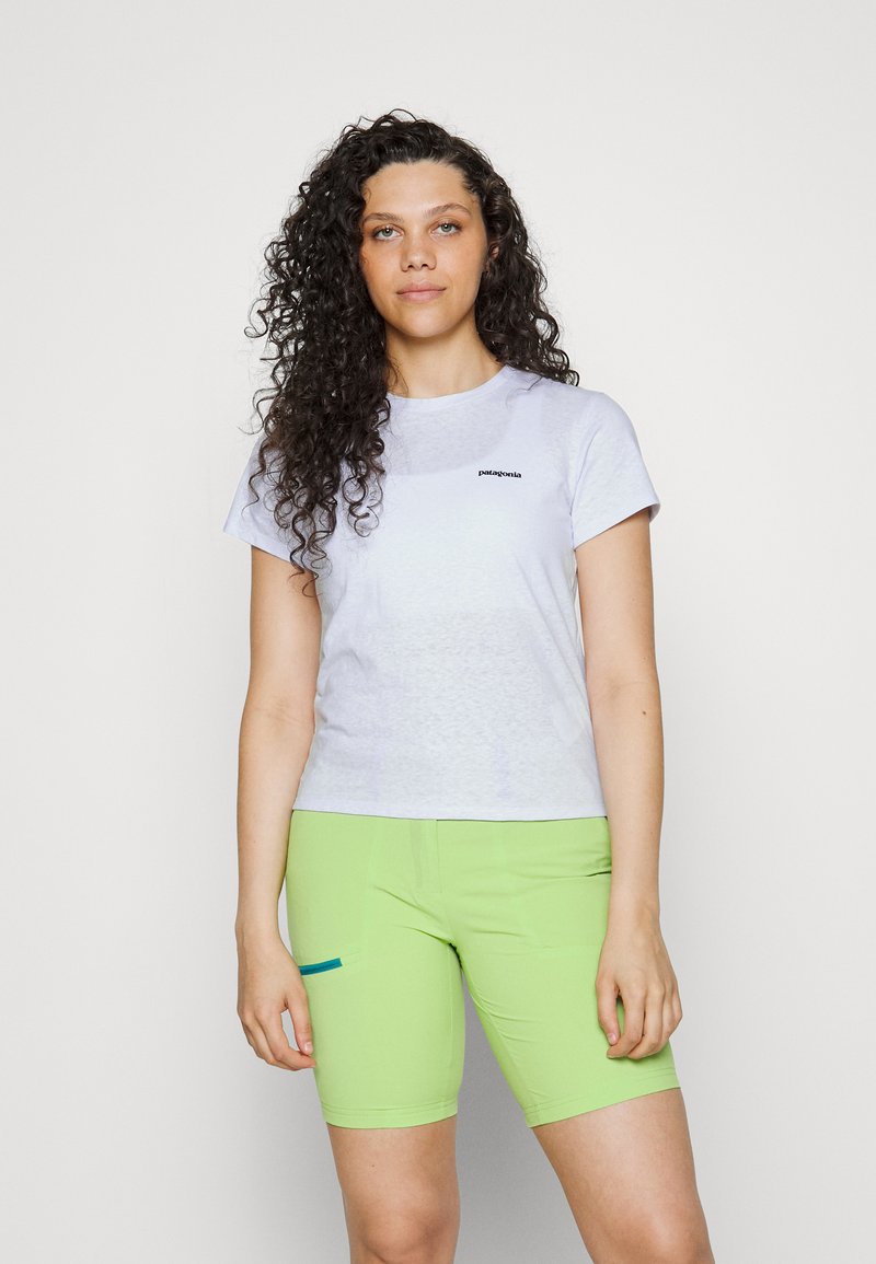 Light gray t-shirt with a black logo, paired with bright green shorts featuring a side pocket and a contrasting blue accent.