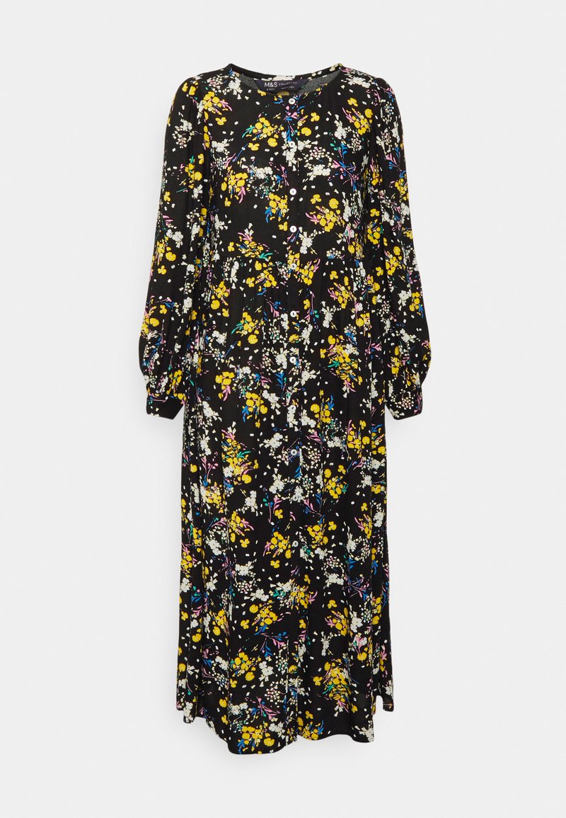 Vestido maxi floral de mangas longas, com fundo preto e padrões de flores multicoloridas em amarelo, branco e rosa. Fecho com botões na frente.