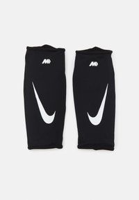 Sorte sportærmer lavet af meshmateriale, med et fremtrædende hvidt Nike swoosh-logo og en tekstureret overflade.