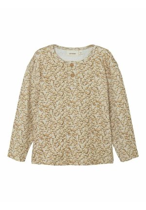 Camisa beige de manga larga con estampado de hojas marrones y verde claro, cuello redondo y dos botones de madera en la tapeta frontal.