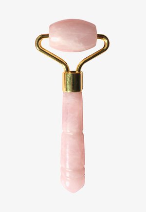 Rose quartz facial roller with a rounded, polished head and a textured pink handle. Gold-tone metal accents connect the components.