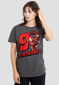 Gray cotton t-shirt featuring a large graphic of Iron Man with the text "9TH BIRTHDAY!" in bold red and black letters. Short sleeves, relaxed fit.
