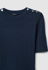 Pull en tricot bleu marine à manches courtes, avec un motif de côtes texturé et trois boutons métalliques à l'épaule.