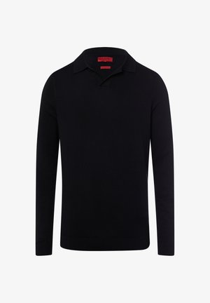 Polo à manches longues noir avec col en V et col standard, en tissu lisse, avec poignets et ourlet côtelés. Étiquette rouge à l'intérieur du col.