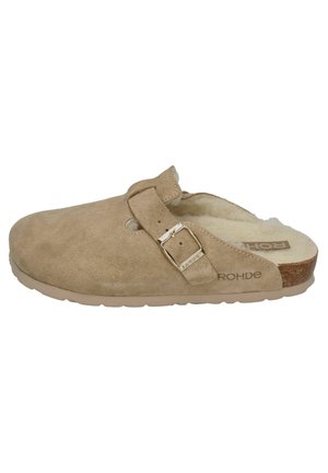 Beige suede clog with a strap and metallic buckle. Fleece-lined interior and cork footbed. Flat rubber sole. Side branding visible.