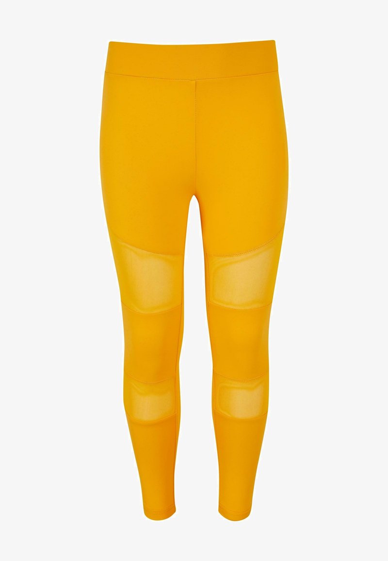 Leggings amarillos de material elástico, con paneles de malla transparente en los muslos y un diseño ajustado y suave.